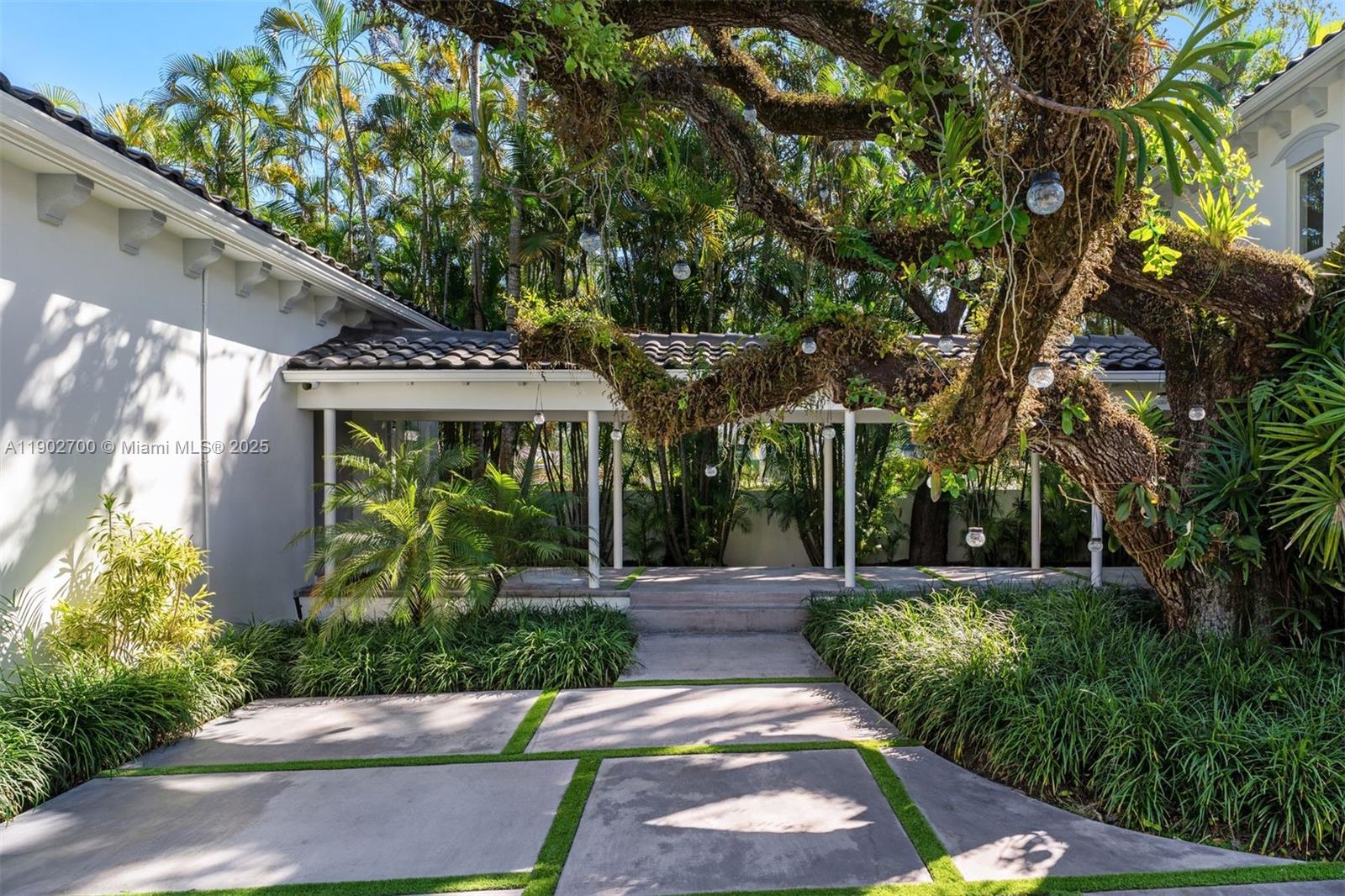 5770 Southwest 100th Street Pinecrest, FL 33156 - Photo 3 of 57 a view of a garden with a fountain