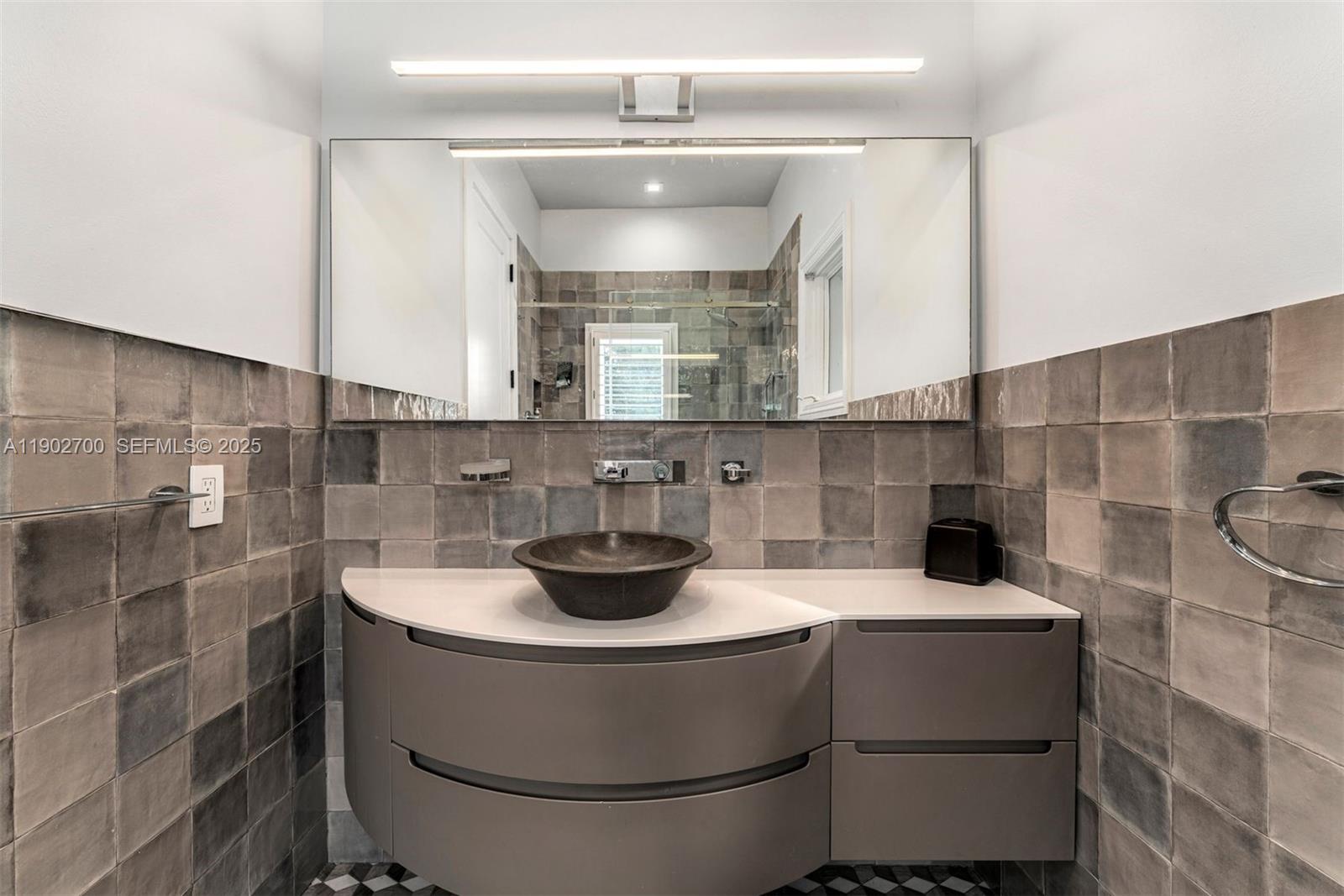 5770 Southwest 100th Street Pinecrest, FL 33156 - Photo 33 of 57 a bathroom with a sink and a mirror