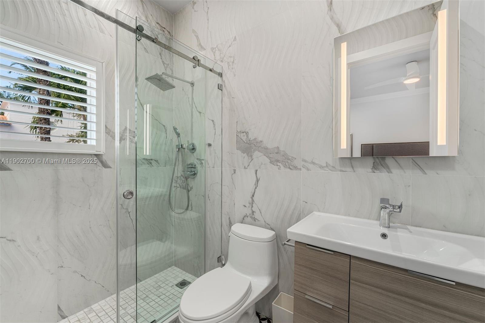 5770 Southwest 100th Street Pinecrest, FL 33156 - Photo 36 of 57 a bathroom with a toilet sink shower and mirror