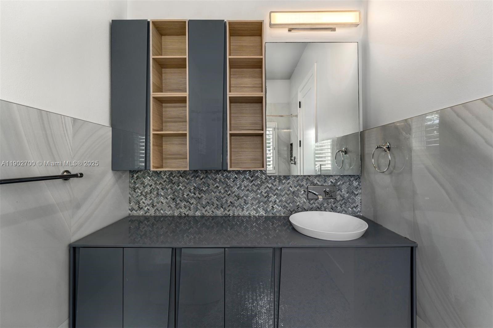 5770 Southwest 100th Street Pinecrest, FL 33156 - Photo 39 of 57 a bathroom with a sink and mirror