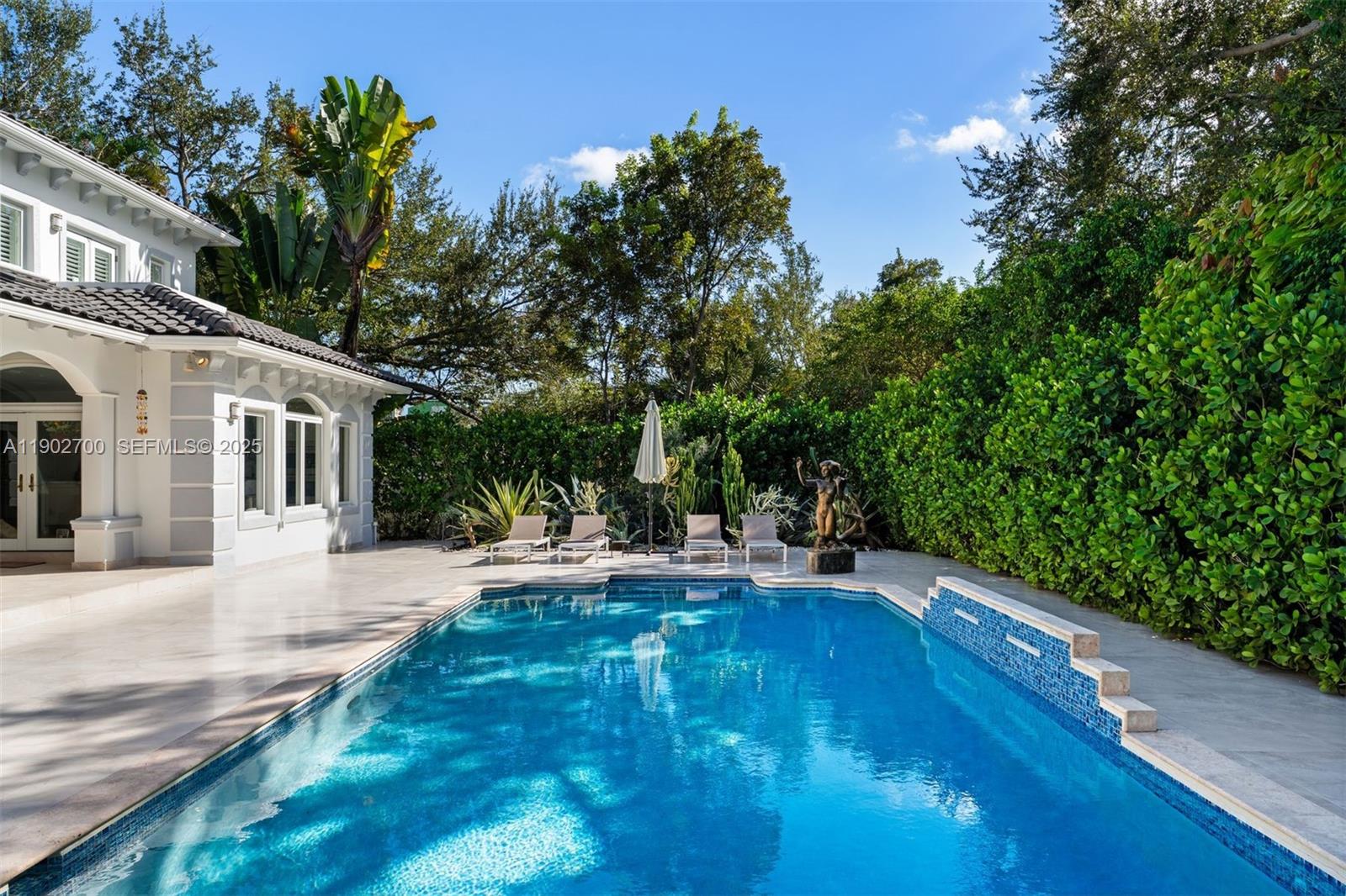 5770 Southwest 100th Street Pinecrest, FL 33156 - Photo 47 of 57 a view of a house with backyard and sitting area