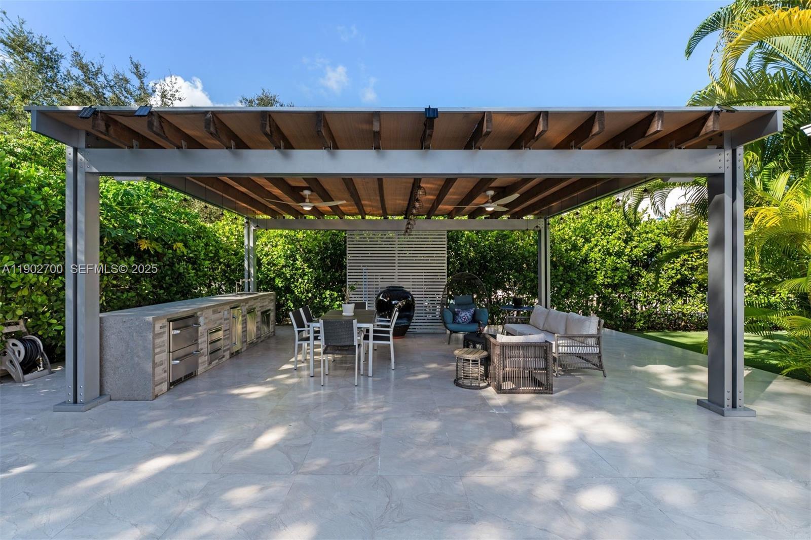 5770 Southwest 100th Street Pinecrest, FL 33156 - Photo 48 of 57 a patio with an outdoor space