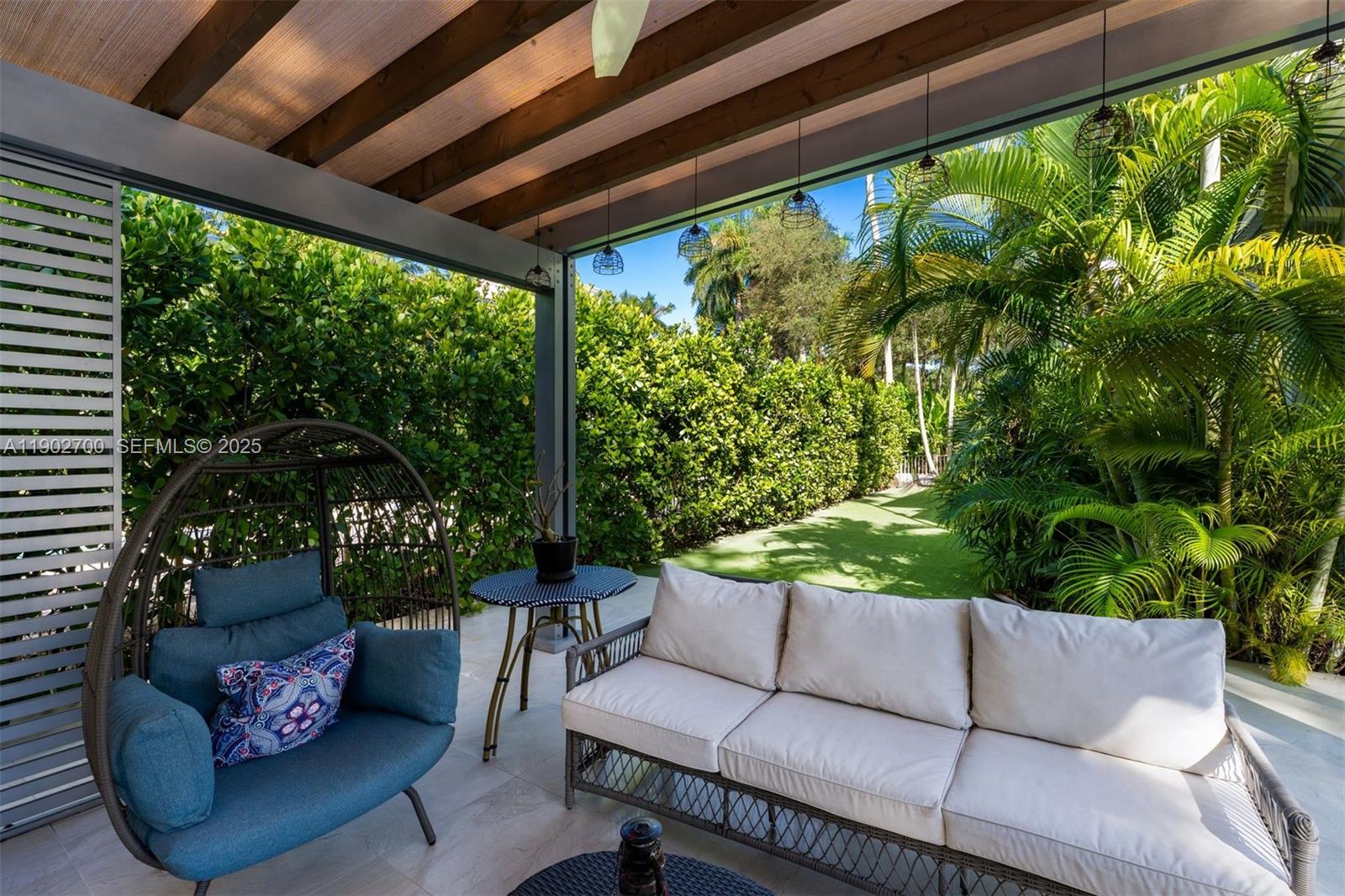 5770 Southwest 100th Street Pinecrest, FL 33156 - Photo 50 of 57 a outdoor living space with furniture and garden view