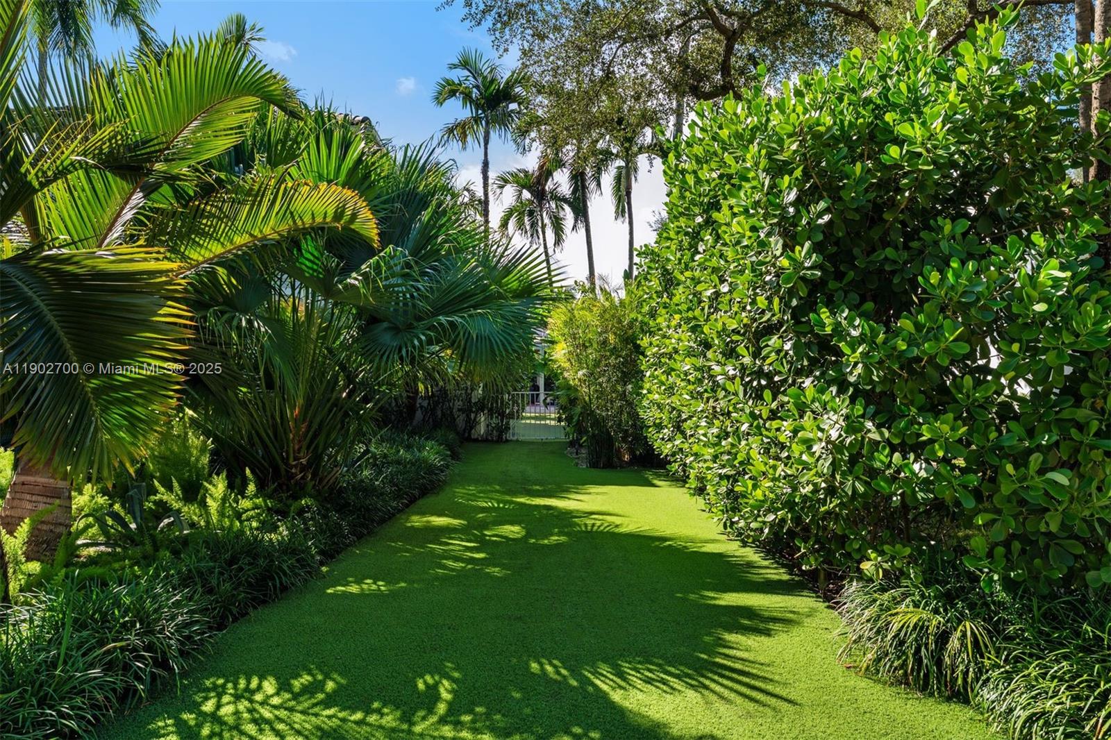 5770 Southwest 100th Street Pinecrest, FL 33156 - Photo 51 of 57 a garden with trees in front of it