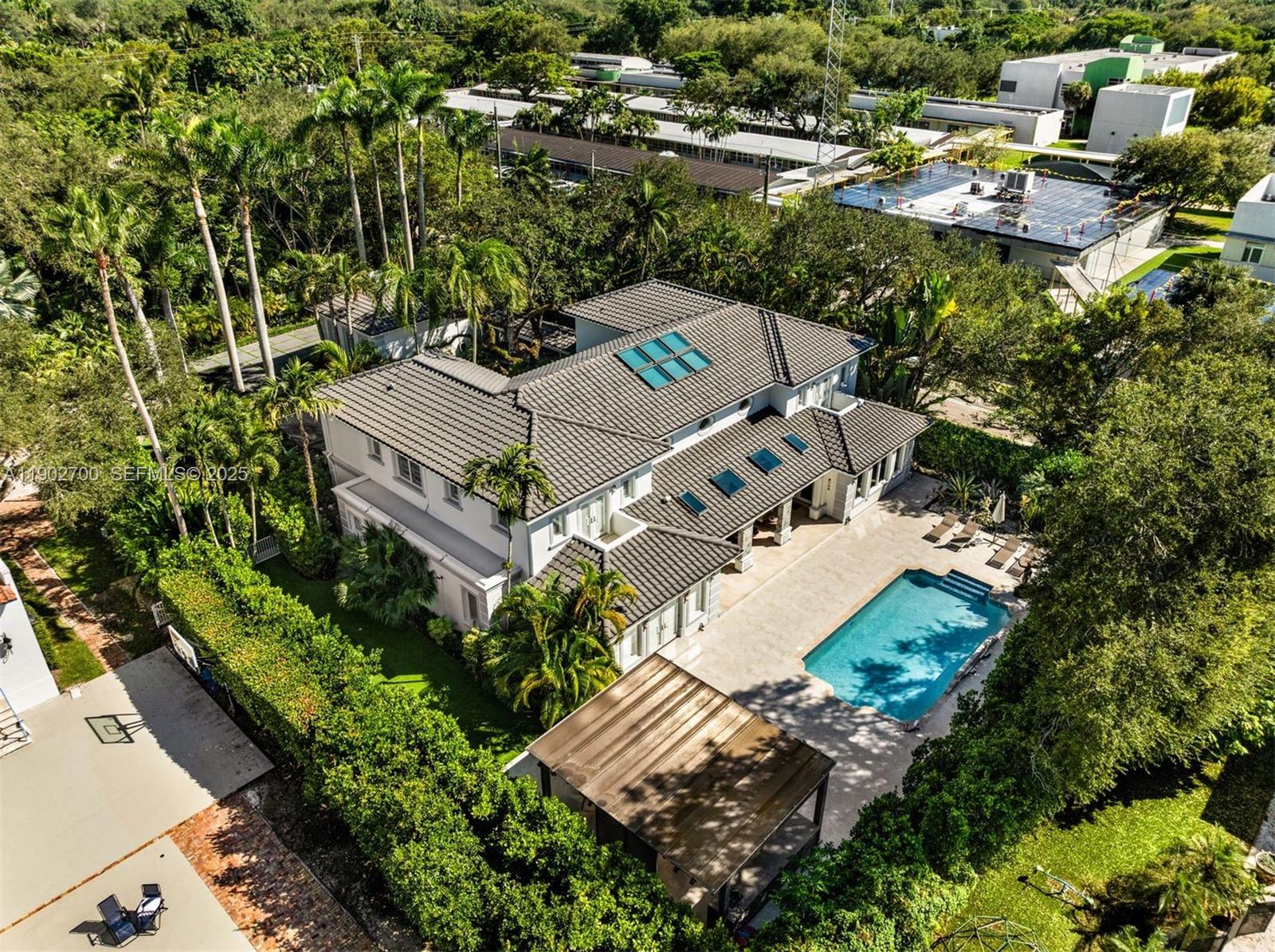 5770 Southwest 100th Street Pinecrest, FL 33156 - Photo 52 of 57 an aerial view of a house with a yard and trees