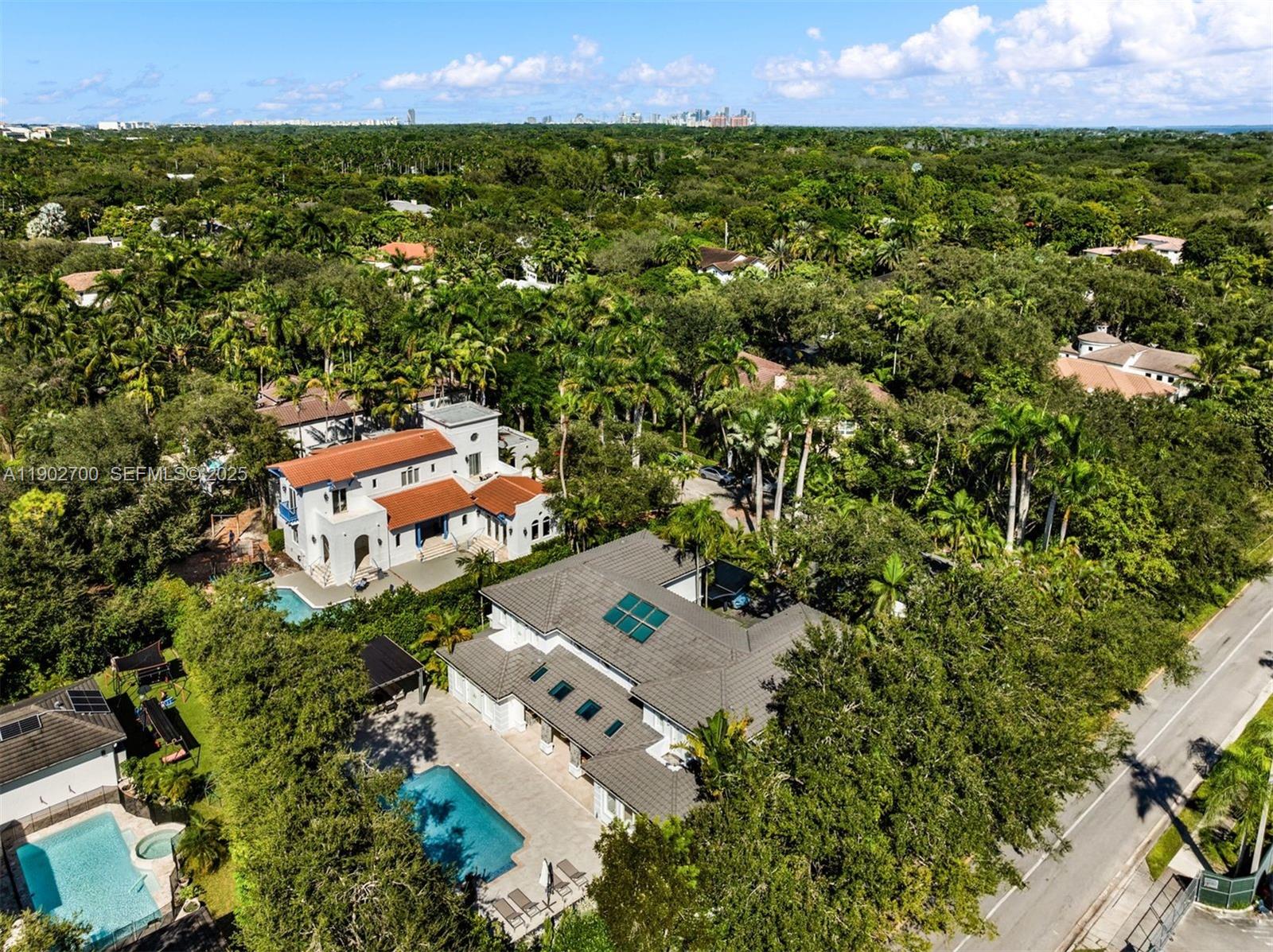 5770 Southwest 100th Street Pinecrest, FL 33156 - Photo 56 of 57 an aerial view of residential houses with outdoor space and trees