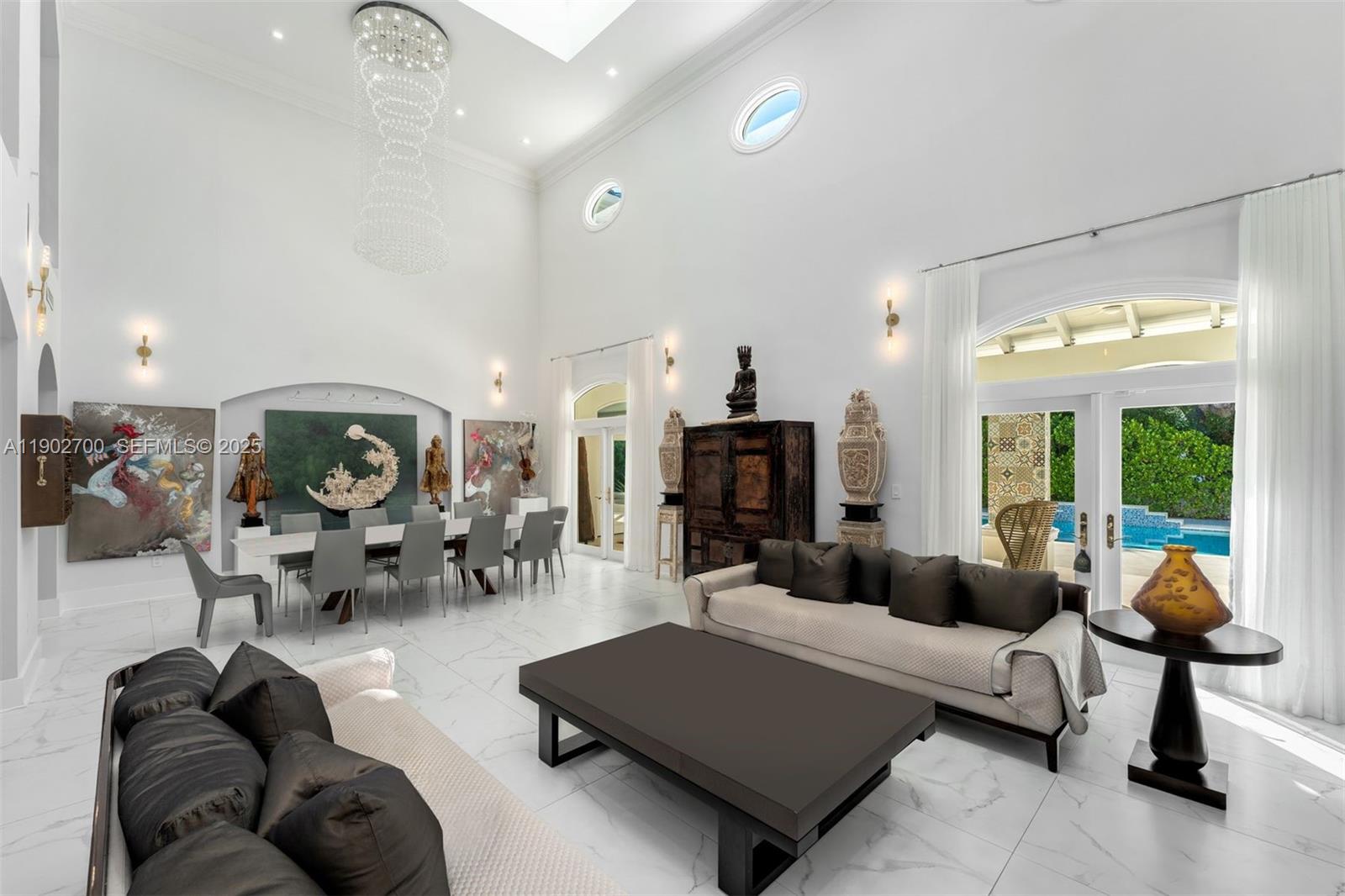 5770 Southwest 100th Street Pinecrest, FL 33156 - Photo 10 of 57 a living room with furniture and a large window