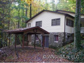 345 Reuben Branch Road Maggie Valley, NC 28751 - Photo 2 of 12 a front view of a house with porch