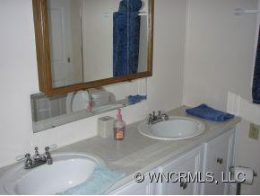 345 Reuben Branch Road Maggie Valley, NC 28751 - Photo 12 of 12 a bathroom with a sink and a mirror