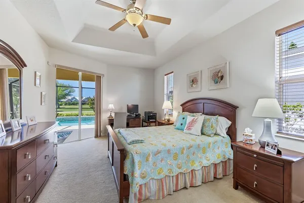 a bedroom with a bed and a lamp on dresser