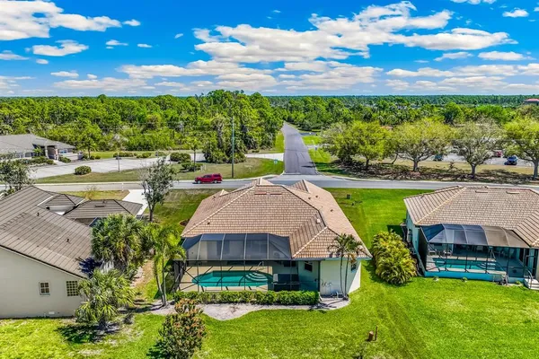 a aerial view of a house with a yard and a fountain