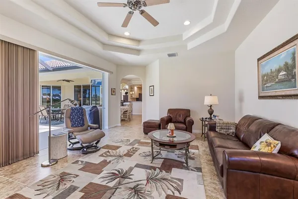 a living room with furniture a rug and a chandelier