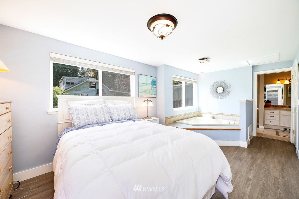 19637 Southeast 149th Street Renton, WA 98059 - Photo 11 of 29 a bedroom with a bed and a table