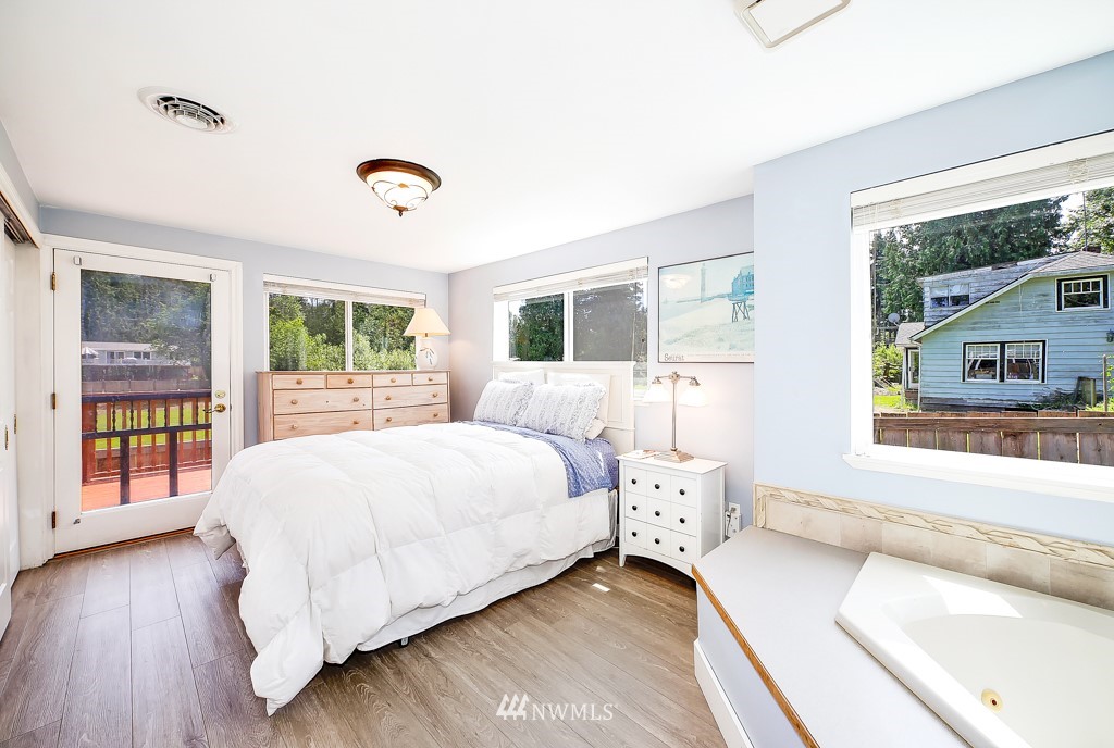 19637 Southeast 149th Street Renton, WA 98059 - Photo 10 of 29 a bedroom with a bed and a large window