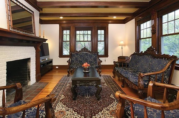 145 University Road, Unit 2 Brookline, MA 02445 - Photo 3 of 7 a living room with furniture a flat screen tv and a fireplace