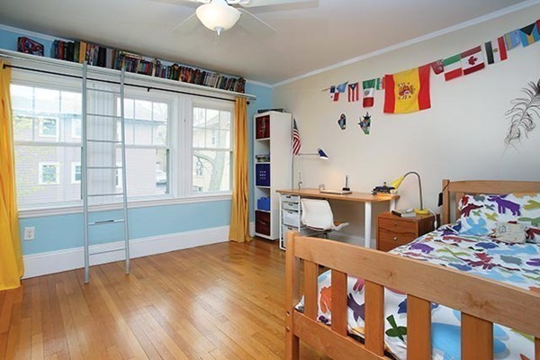 145 University Road, Unit 2 Brookline, MA 02445 - Photo 6 of 7 a bedroom with furniture and a book shelf