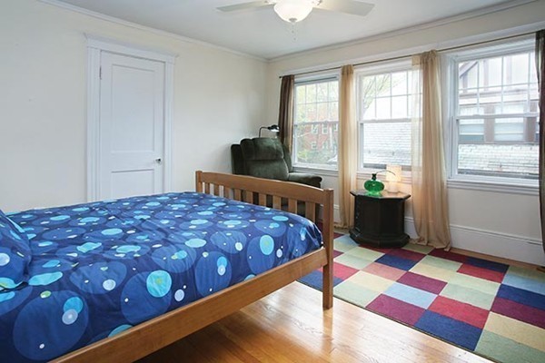 145 University Road, Unit 2 Brookline, MA 02445 - Photo 7 of 7 a bedroom with a bed and a lamp on dresser