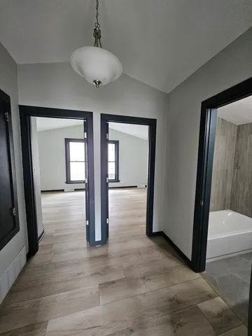 a view of livingroom with hardwood floor and front door