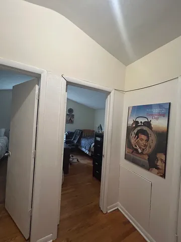 a view of a hallway with paintings on the wall