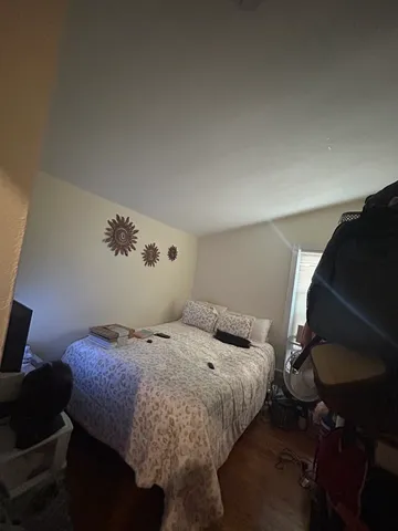 a bedroom with a bed and dresser