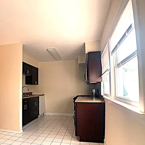 a kitchen with a sink a counter top space and appliances