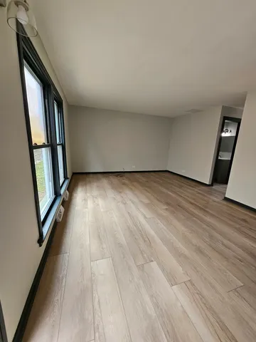 a view of a room with wooden floor and staircase