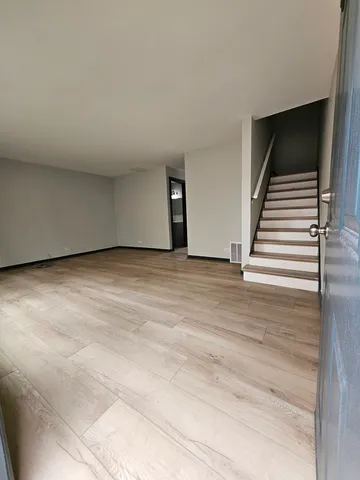 a view of an empty room with stairs