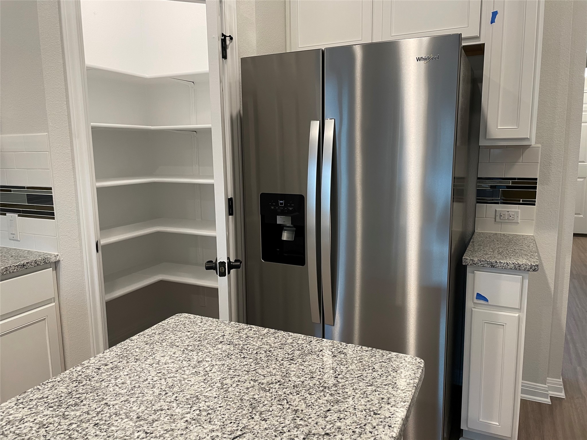 3908 Birdwatch Loop, Unit 56 Pflugerville, TX 78660 - Photo 28 of 30 a kitchen with stainless steel appliances a refrigerator and cabinets