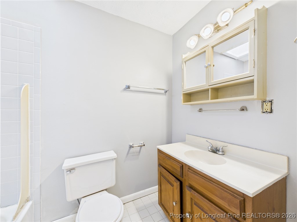 1540 Mack Street Spring Lake, NC 28390 - Photo 16 of 31 a bathroom with a sink a toilet and mirror