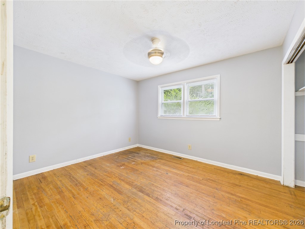 1540 Mack Street Spring Lake, NC 28390 - Photo 21 of 31 a view of an empty room with wooden floor and a window