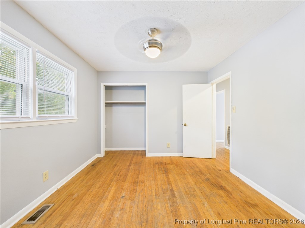1540 Mack Street Spring Lake, NC 28390 - Photo 22 of 31 a view of empty room with wooden floor and fan