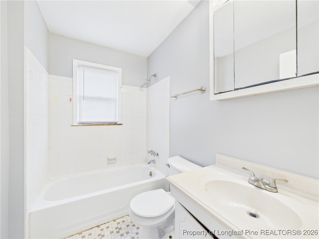 1540 Mack Street Spring Lake, NC 28390 - Photo 24 of 31 a bathroom with a sink a toilet and a bathtub