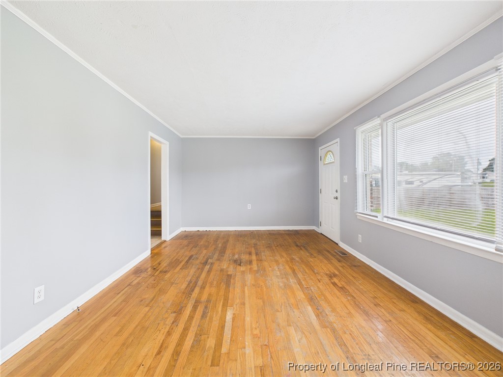 1540 Mack Street Spring Lake, NC 28390 - Photo 6 of 31 a view of empty room with wooden floor and fan