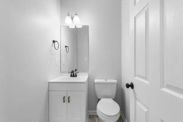 a bathroom with a toilet a sink and a mirror