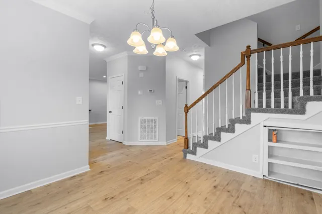 a view of entryway and hall with wooden floor