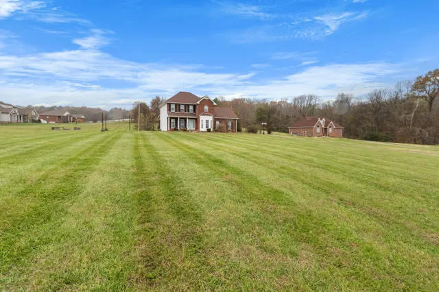 a aerial view of a house with big yard