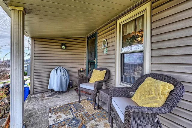 a view of two chairs in the balcony