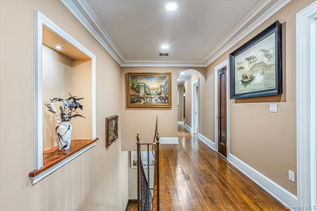 952 Cedar Swamp Road Glen Head, NY 11545 - Photo 21 of 50 a view of a hallway with wooden floor and furniture