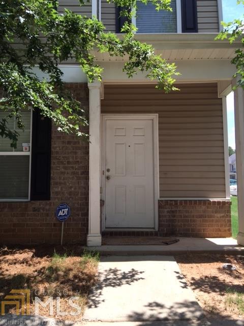 1741 Broad River Road, Unit 108 Atlanta, GA 30349 - Photo 1 of 1 a front view of a house with a yard