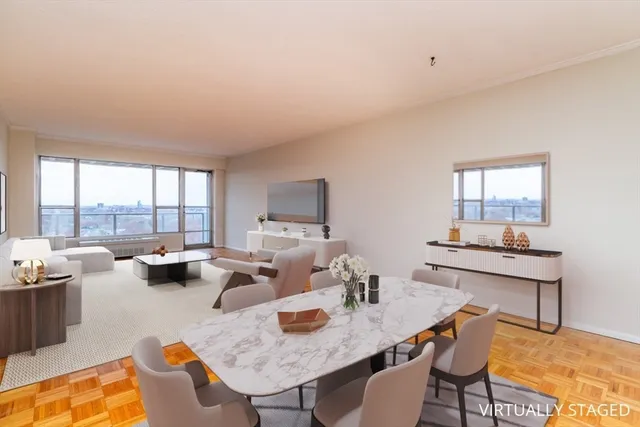 a dining room with furniture and a large window