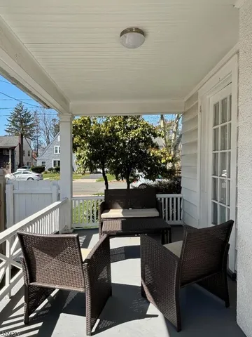 a view of a chairs and table in patio of the house