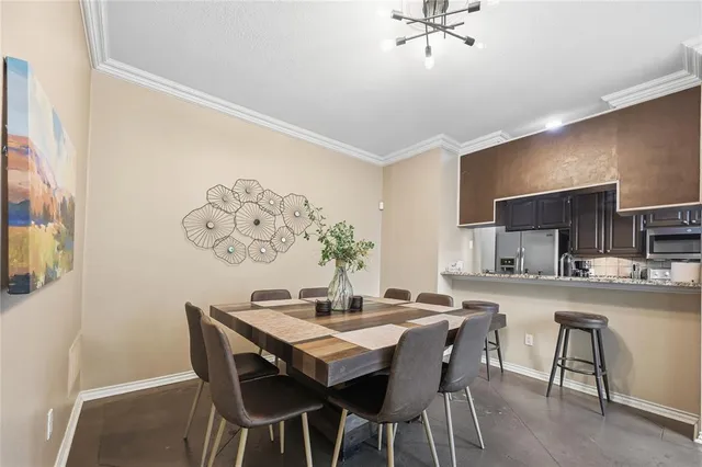 a kitchen with a dining table and chairs