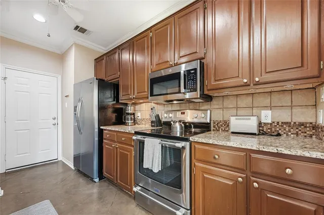 a kitchen with granite countertop stainless steel appliances and cabinets