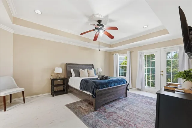 a living room with a bed furniture and a large window