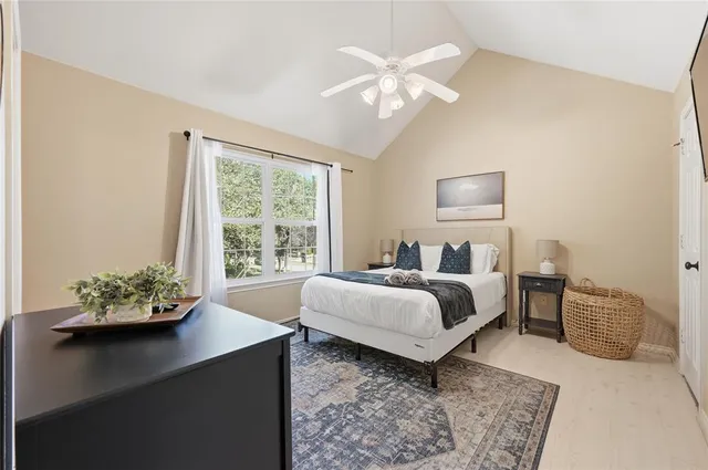 a bedroom with a bed table and chair