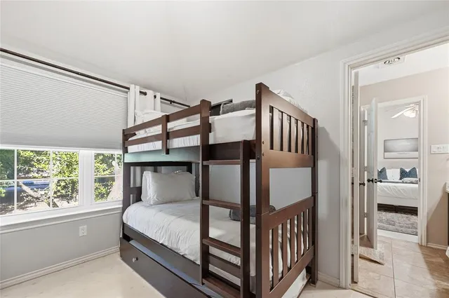 a bedroom with furniture and a window