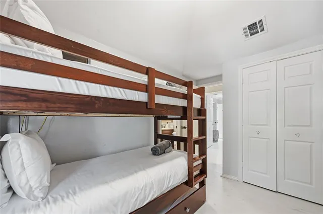 a bedroom with a bed and a cabinet