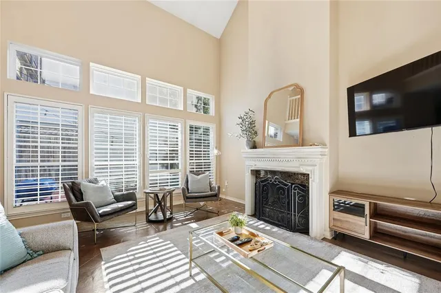 a living room with furniture fireplace and flat screen tv