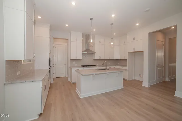 a kitchen with a sink stainless steel appliances and cabinets