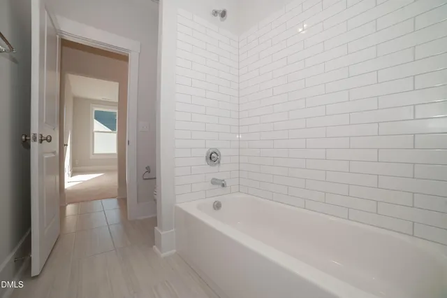 a bathroom with a bathtub and shower